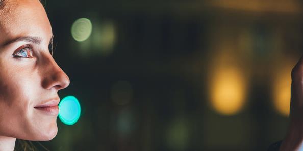 A woman is putting her finger on a touch screen.