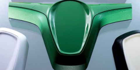 Green car body part made of polyurethane components.