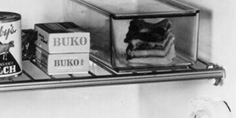 Old black and white close-up of various products in a refrigerator in which rigid foam was used for insulation.