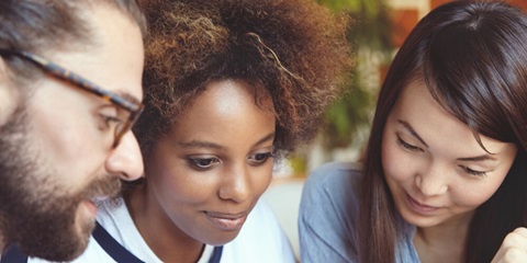 Young people together looking at something