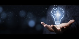 Hand with a light bulb that is partly shaped like a brain